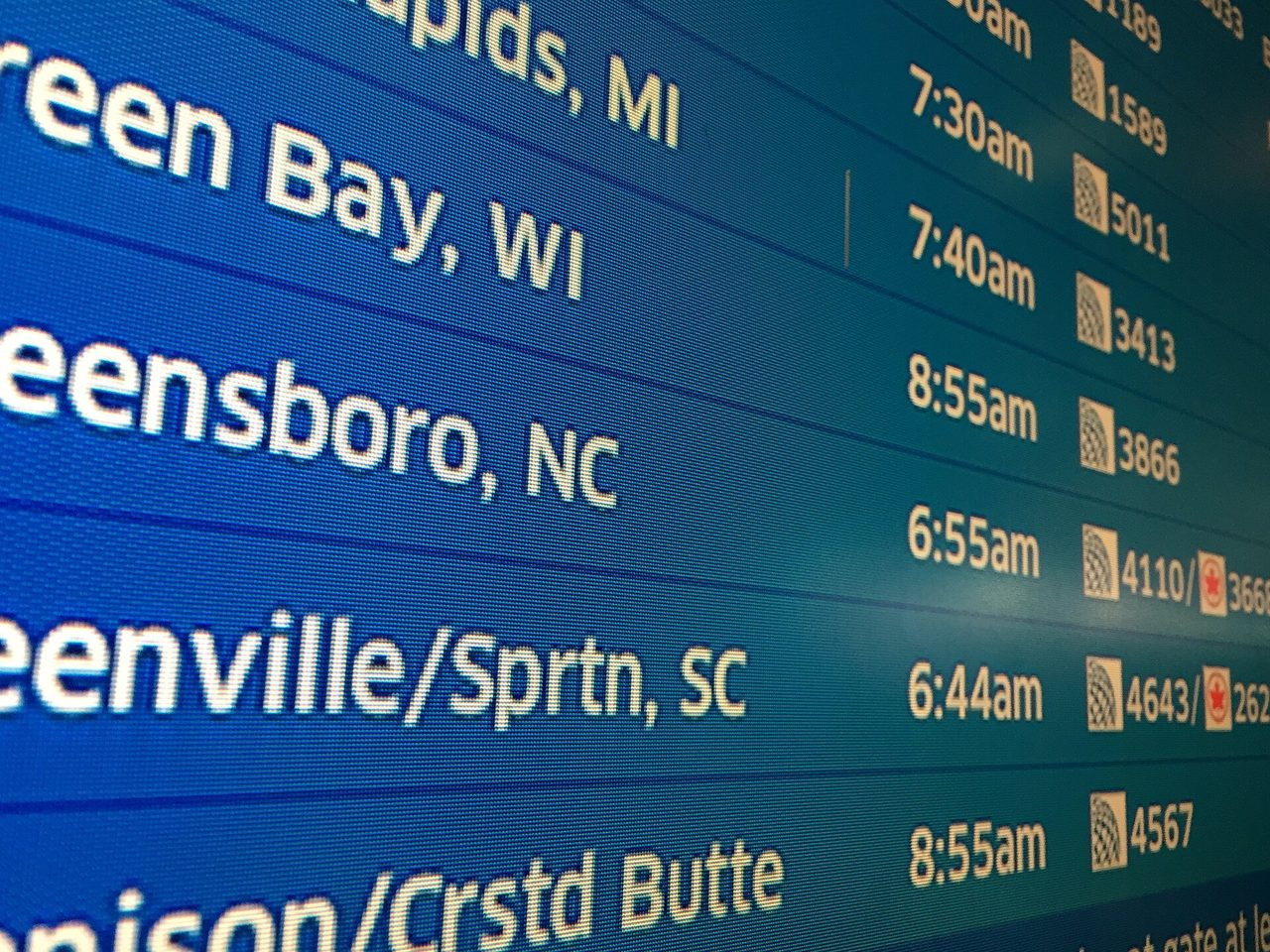 Airport departure board listing connecting flights and departure times