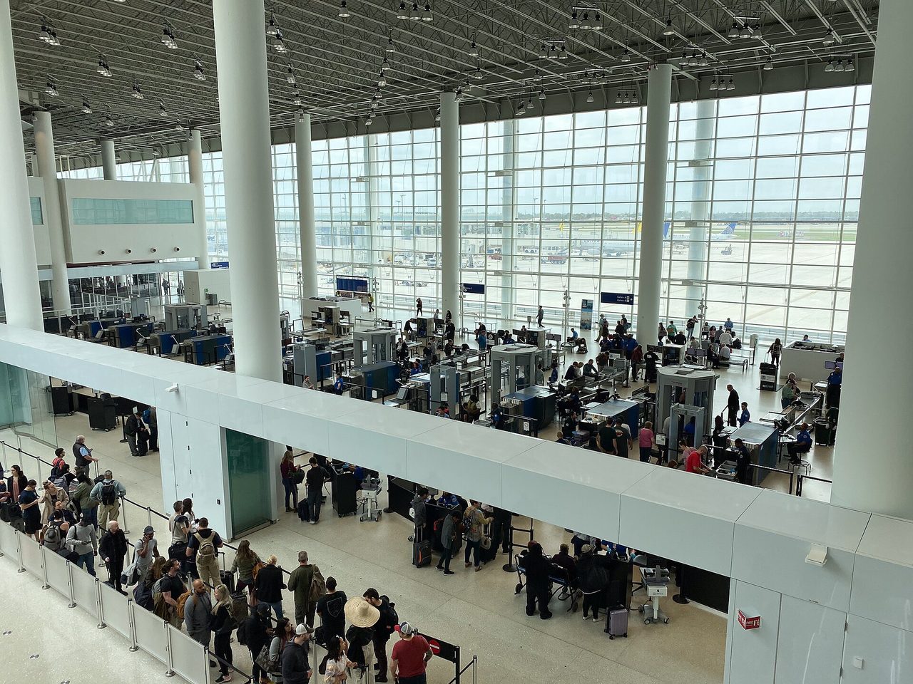 Passengers queuing at an airport security screening checkpoint
