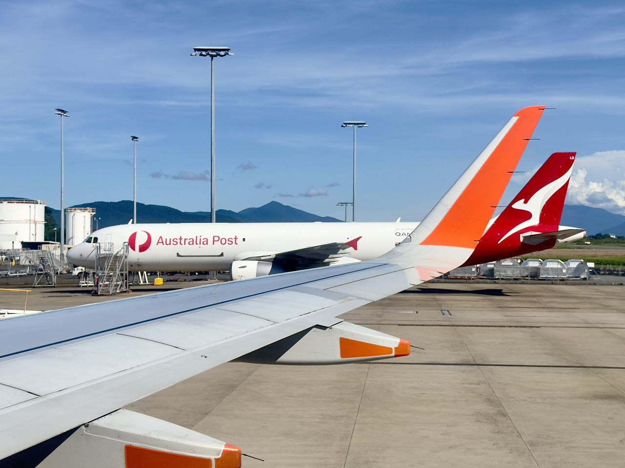 Traveller looking out of a terminal window towards the apron